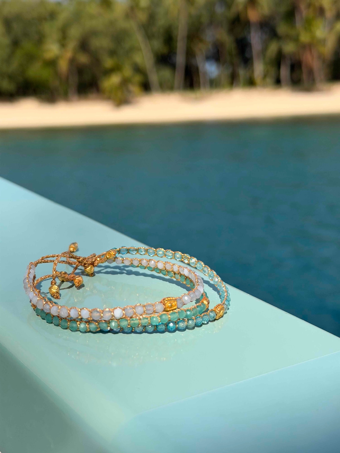 Stacked gemstone bracelets on a woman's wrists